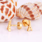 Eiffel Tower gold earrings flat lay – poke free children's earrings by Twisty Locks