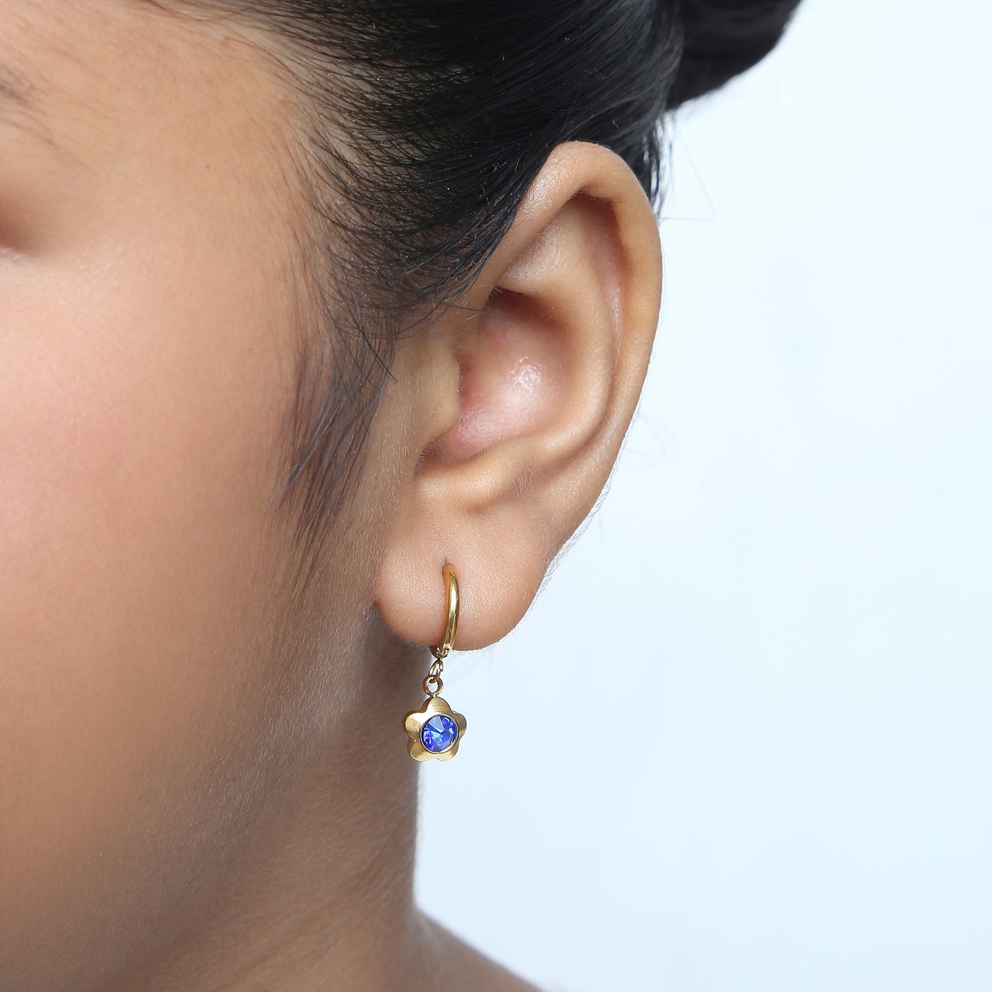 Girl wearing Sapphire Flower Hoops gold earrings – kids jewellery by Twisty Locks